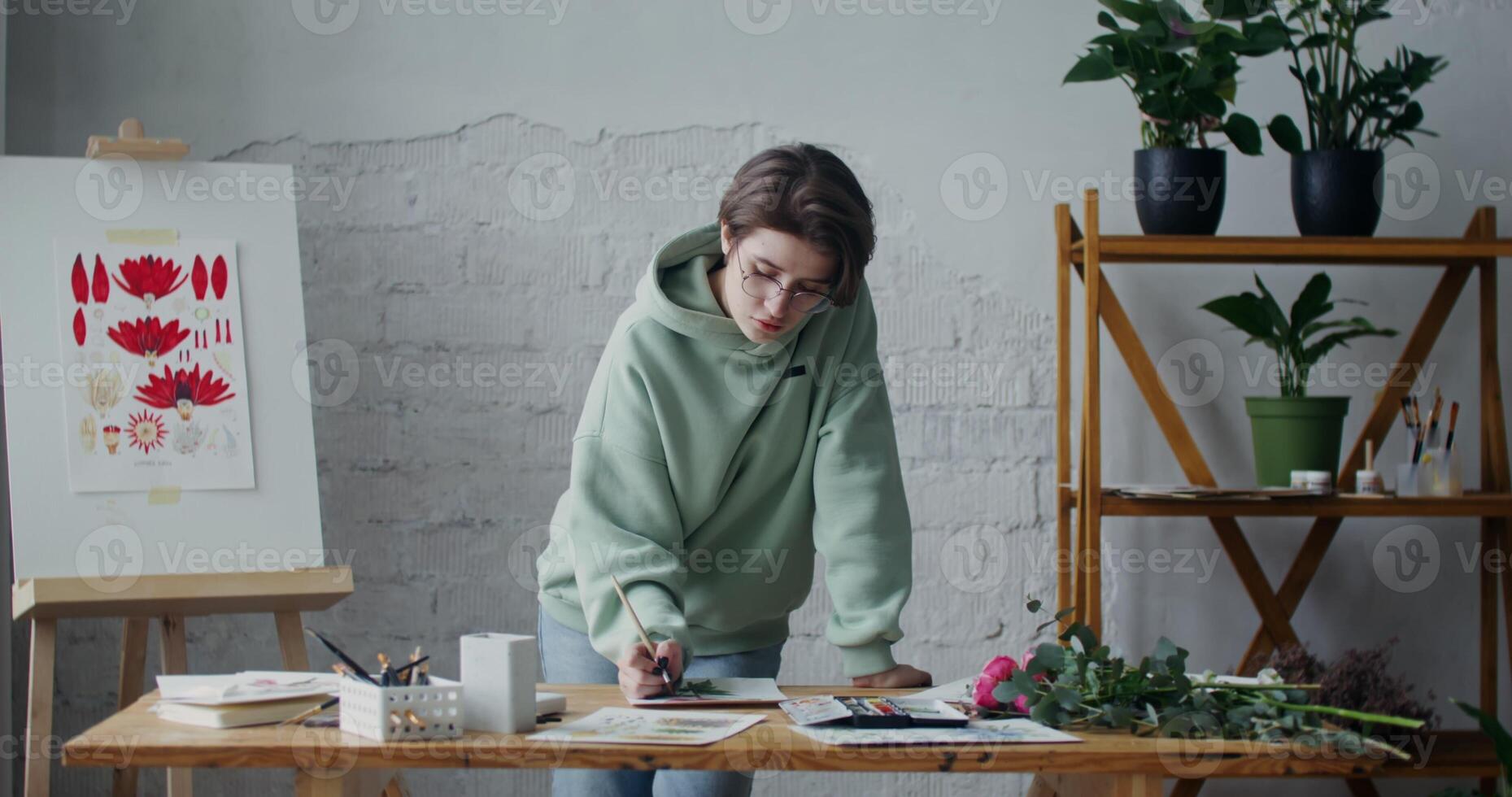 A woman is working on a piece of art photo