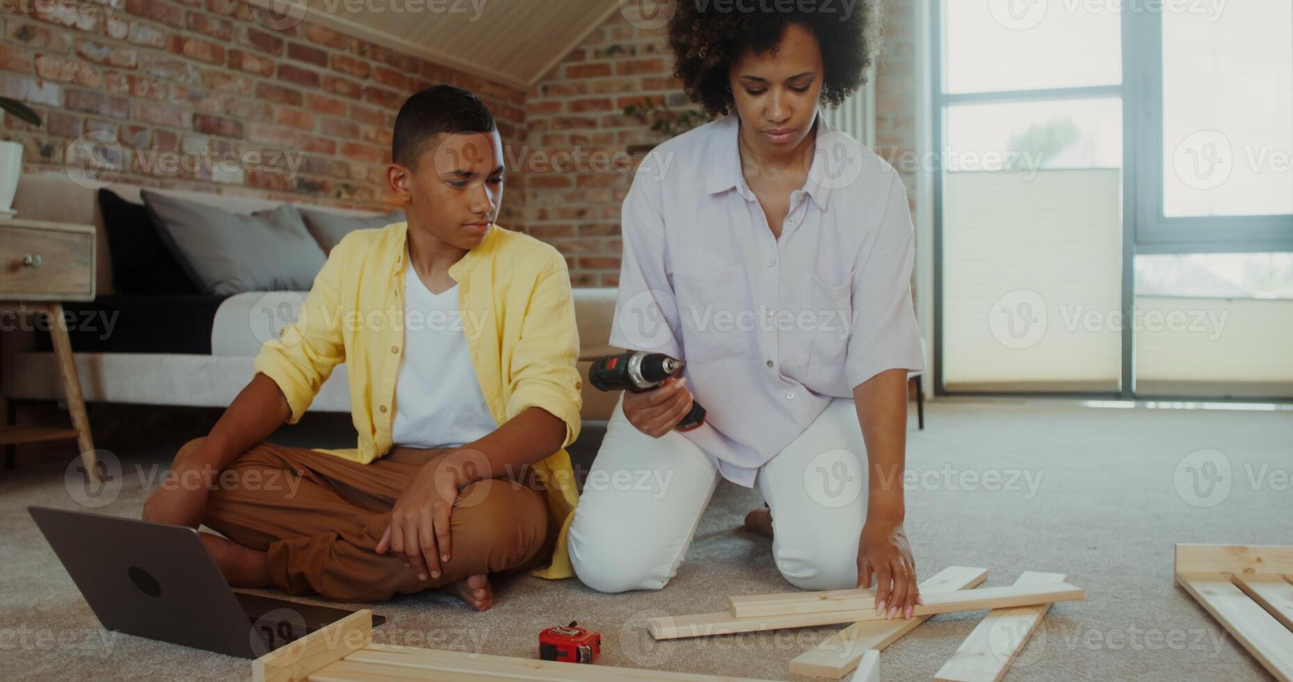 A woman and a boy are working on a project photo