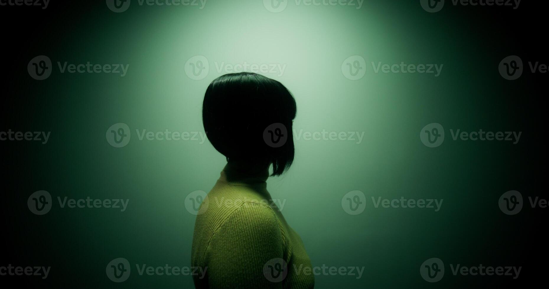 A woman in a wig turns around on the spot, lamps of different colors blink, an unrecognizable person photo