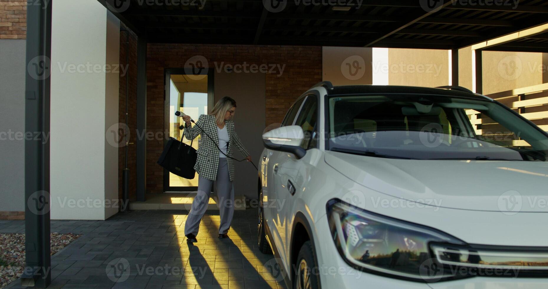 A woman is getting into her car photo