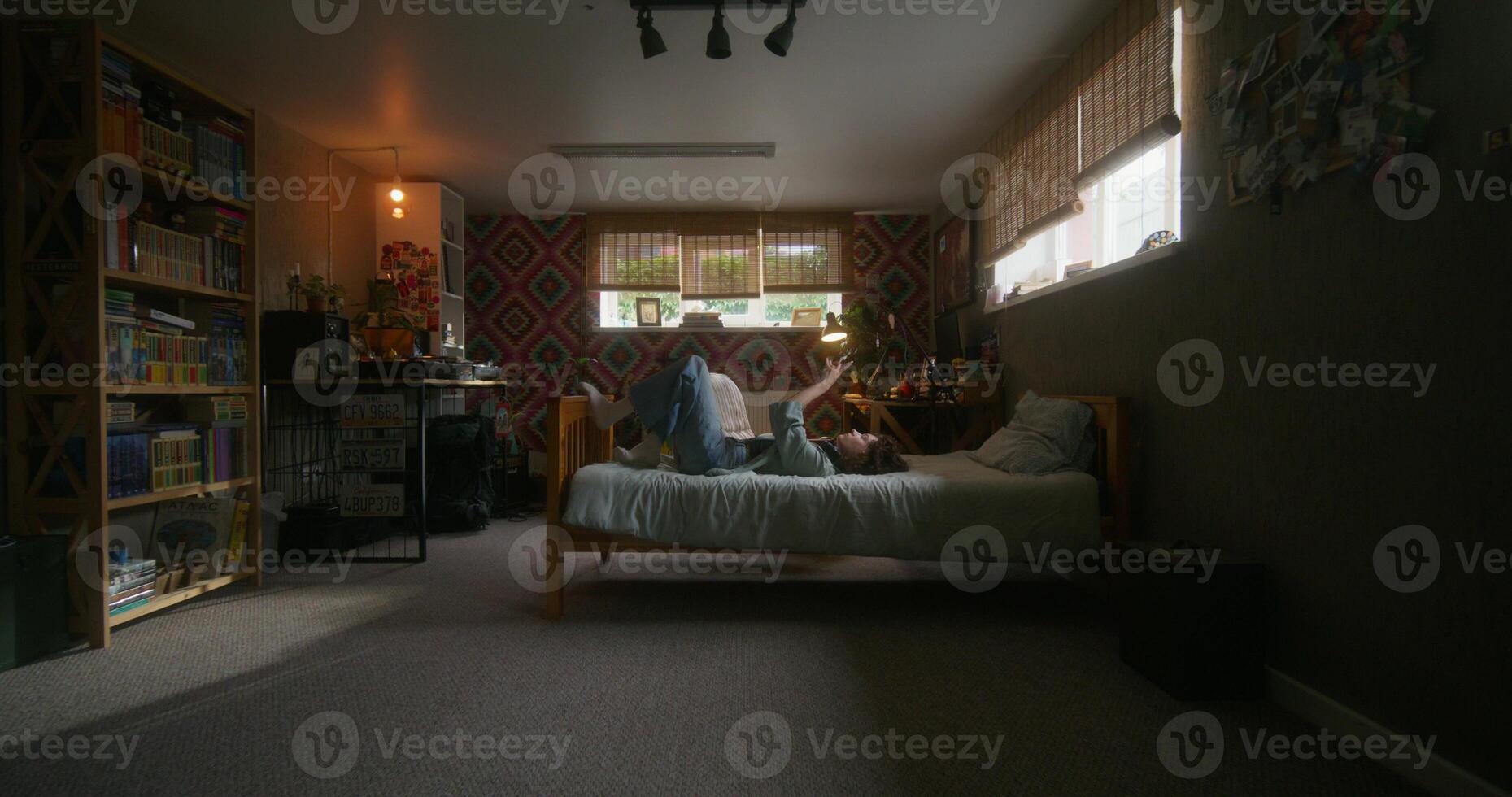 A young woman uses a mobile phone at home with a sad look. A quick change of frames, a woman moves around the room photo