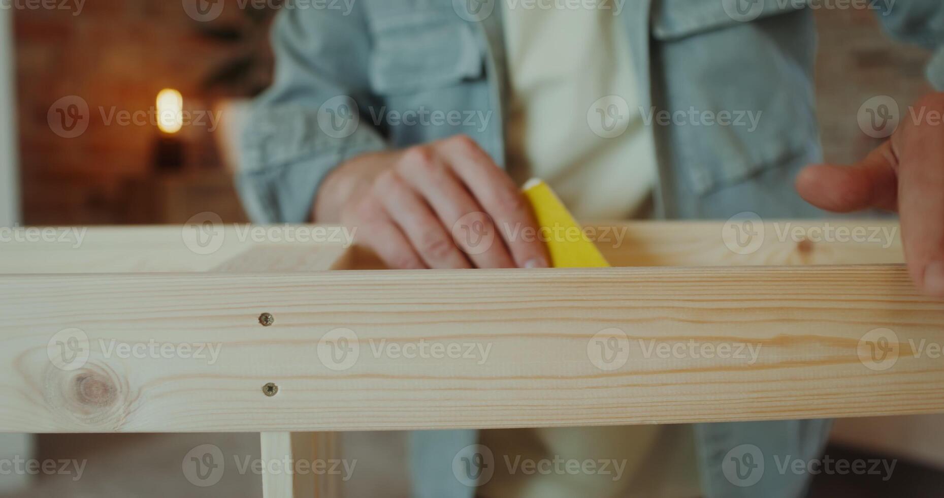 A man polish a rack with sandpaper in a stylish home interior, close-up of his hands, no face photo