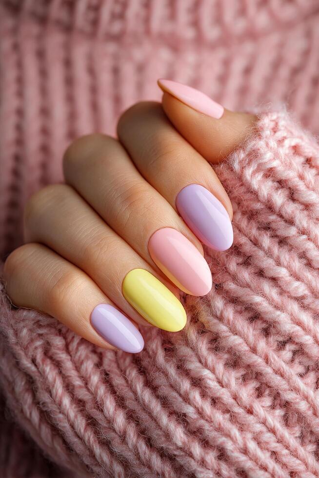 Trendy Pastel Nail Art Showcased on Hand With Cozy Knit Sweater in Soft Pink Hue photo