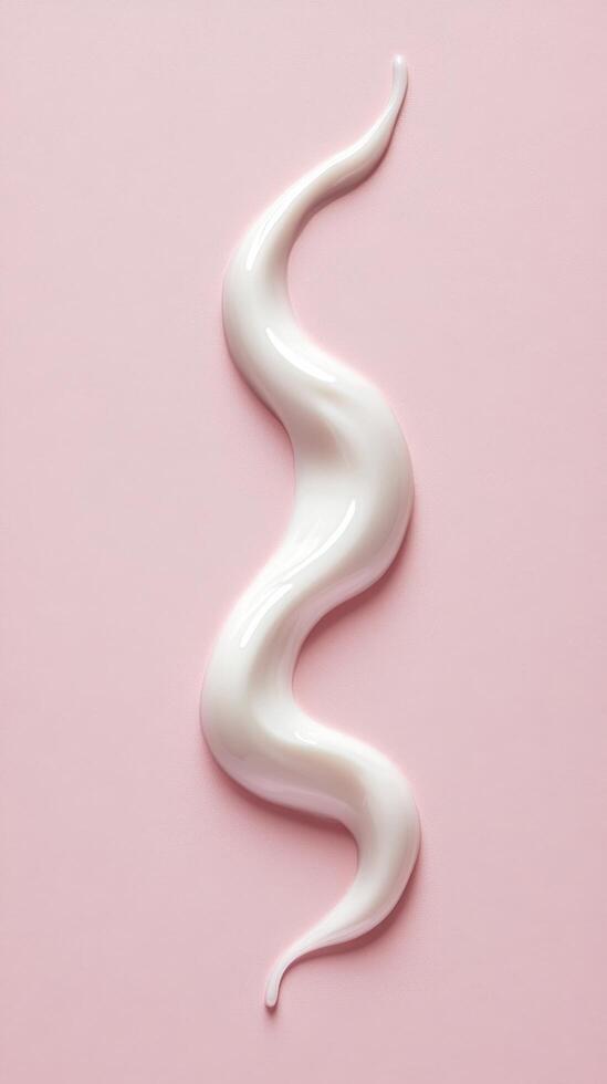 Creamy White Swirl on Pink Surface Creating a Smooth Texture and Visual Appeal photo