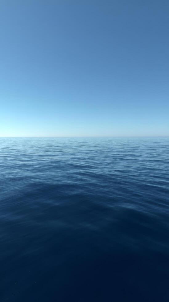 Calm Ocean Surface Under a Clear Blue Sky on a Serene Day by the Coast photo