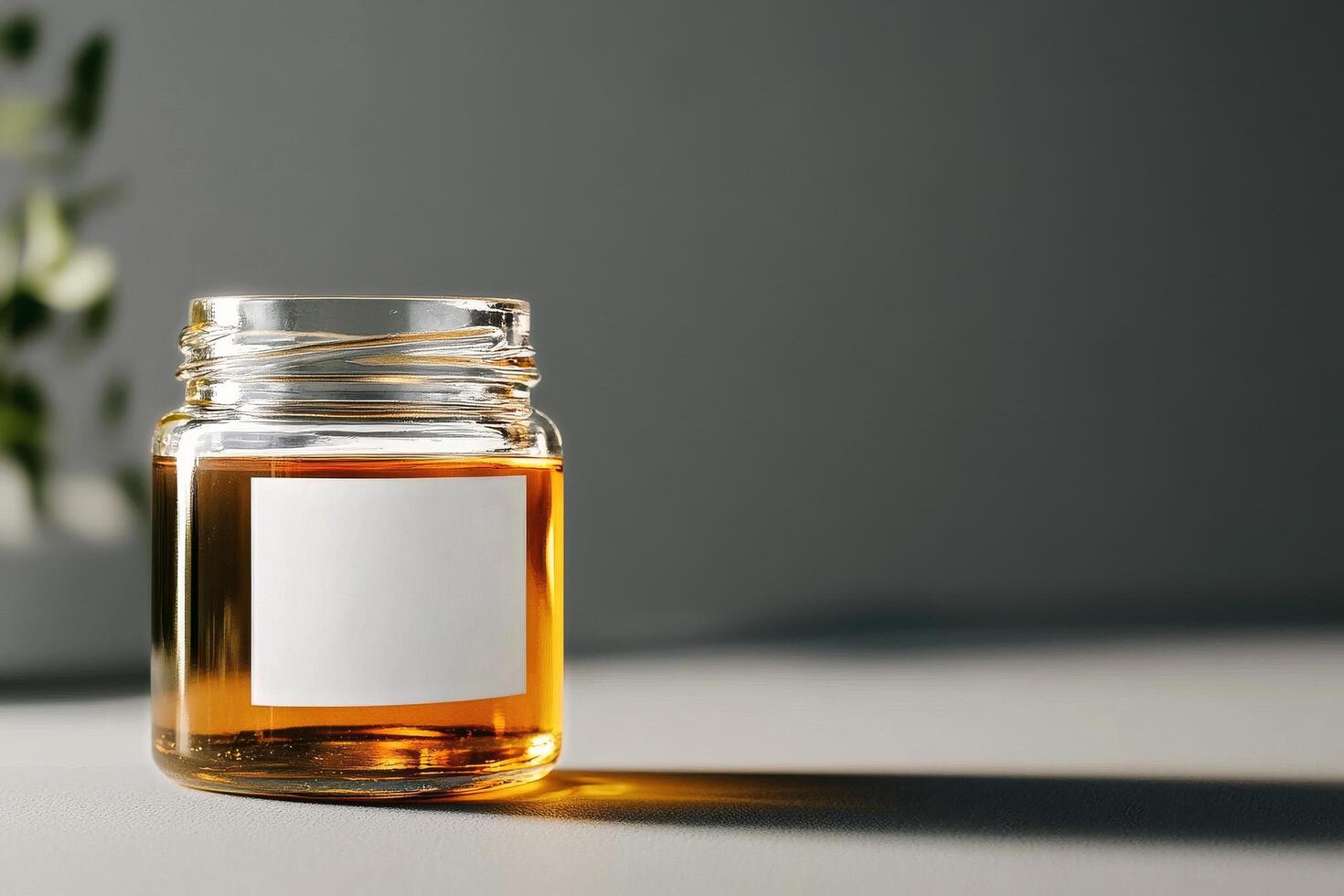 Jar of Amber Liquid on a Neutral Background With Soft Shadows Created by Natural Light photo
