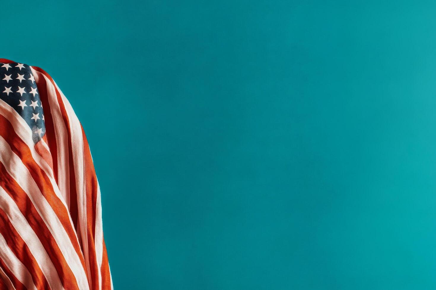 American Flag Draped on a Teal Surface Creating a Patriotic Visual Contrast. photo