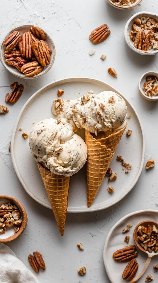 Delicious Pecan Ice Cream Served in Waffle Cones With Nuts on a Light Surface photo