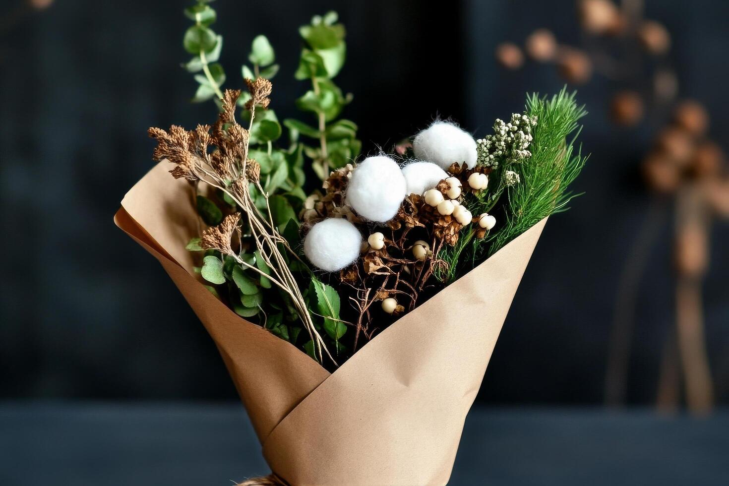 Unique Bouquet of Dried Flowers and Greenery Held in a Hand Surrounded by Natural Background. photo