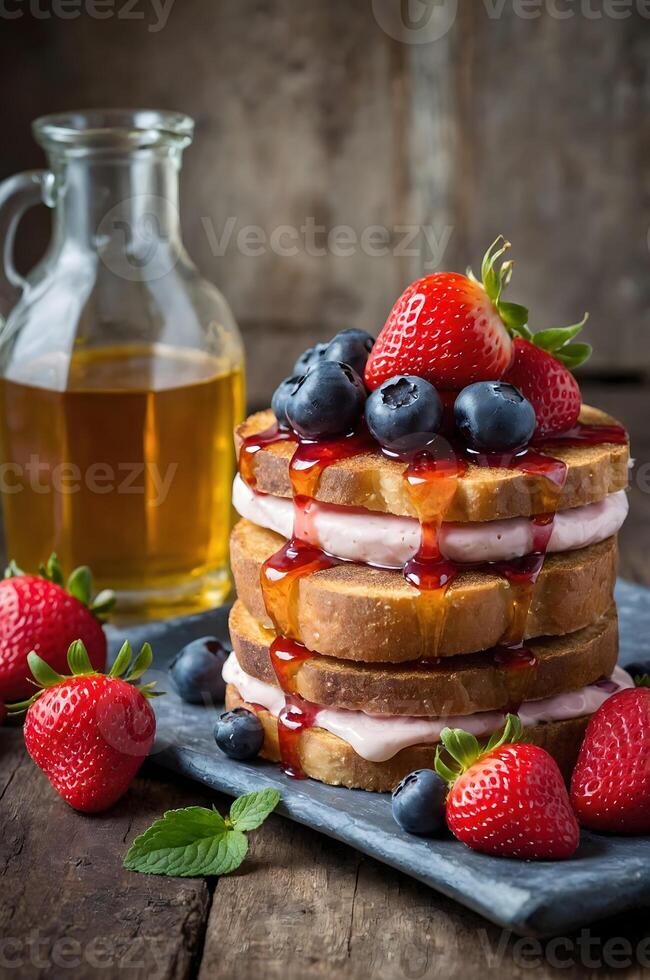 A stack of pancakes with strawberries and syrup photo