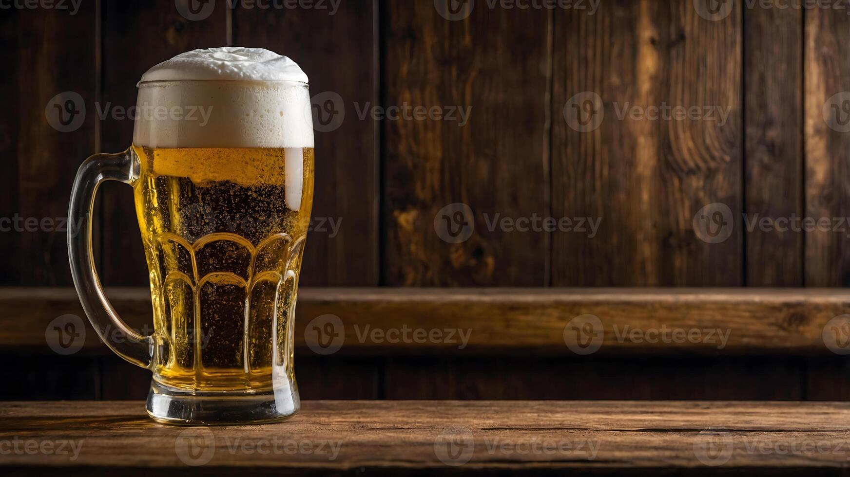 A beer glass with foam on top of a wooden table photo