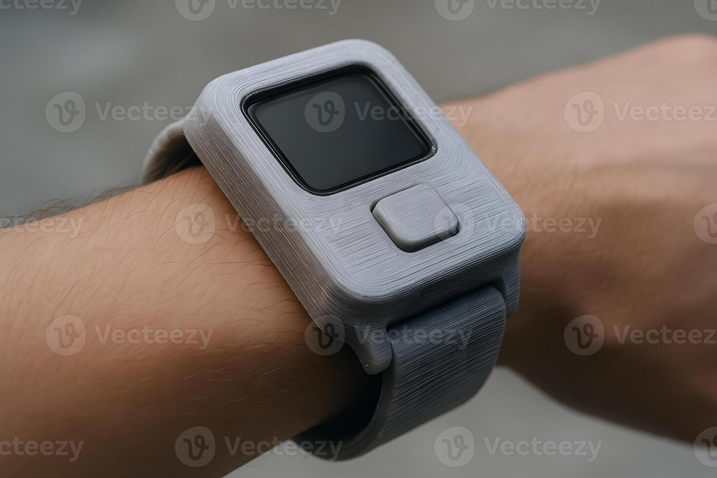 A person wearing a gray watch on their wrist photo