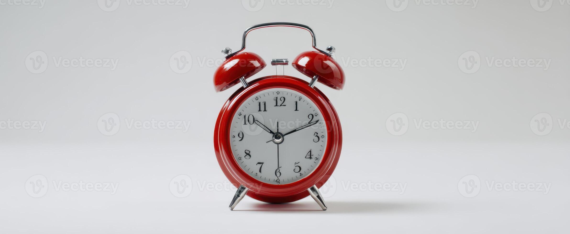The vibrant red alarm clock highlighting the importance of time management in daily life. photo