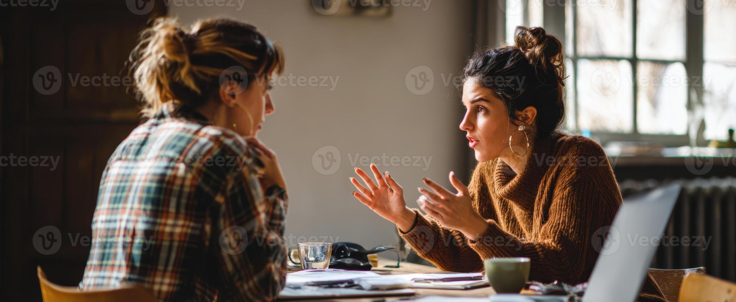 The engaging conversation between two friends in a cozy indoor setting. photo