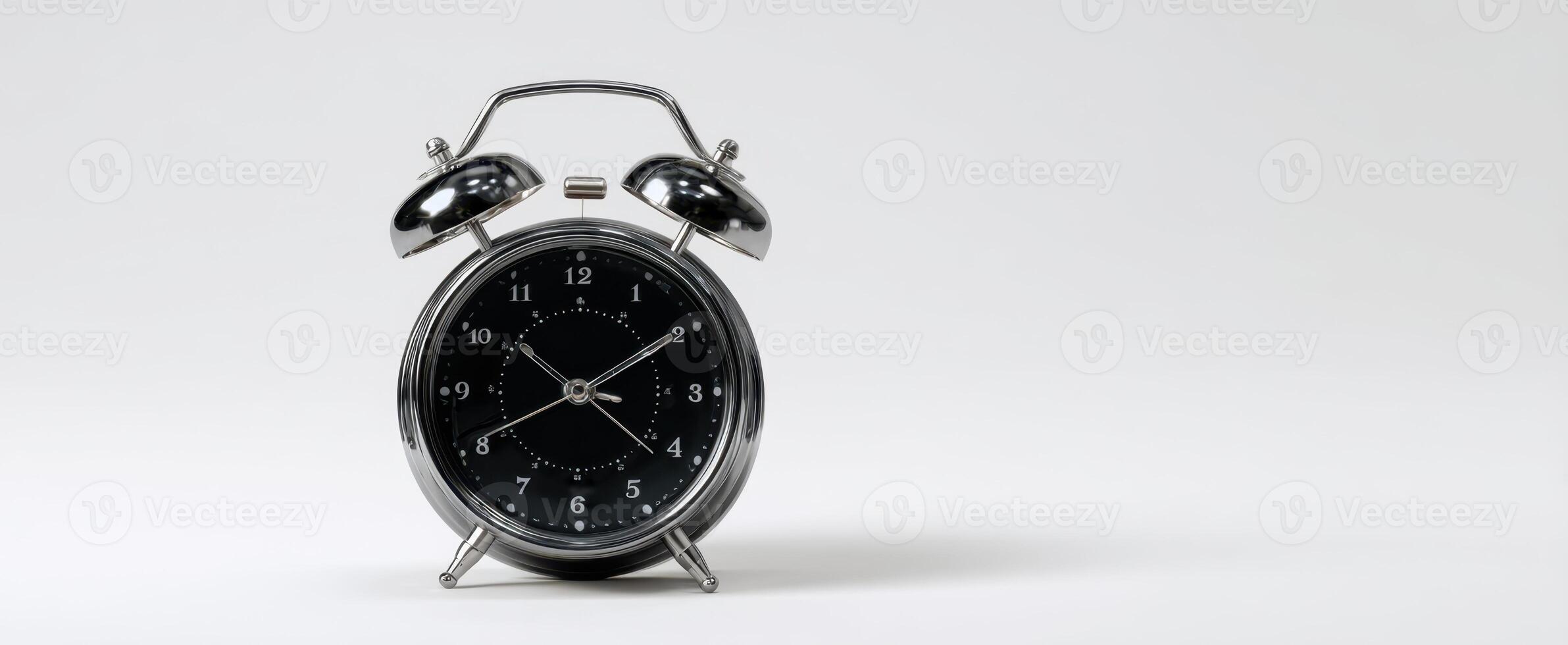 The classic alarm clock with a sleek black design on a minimalist surface photo