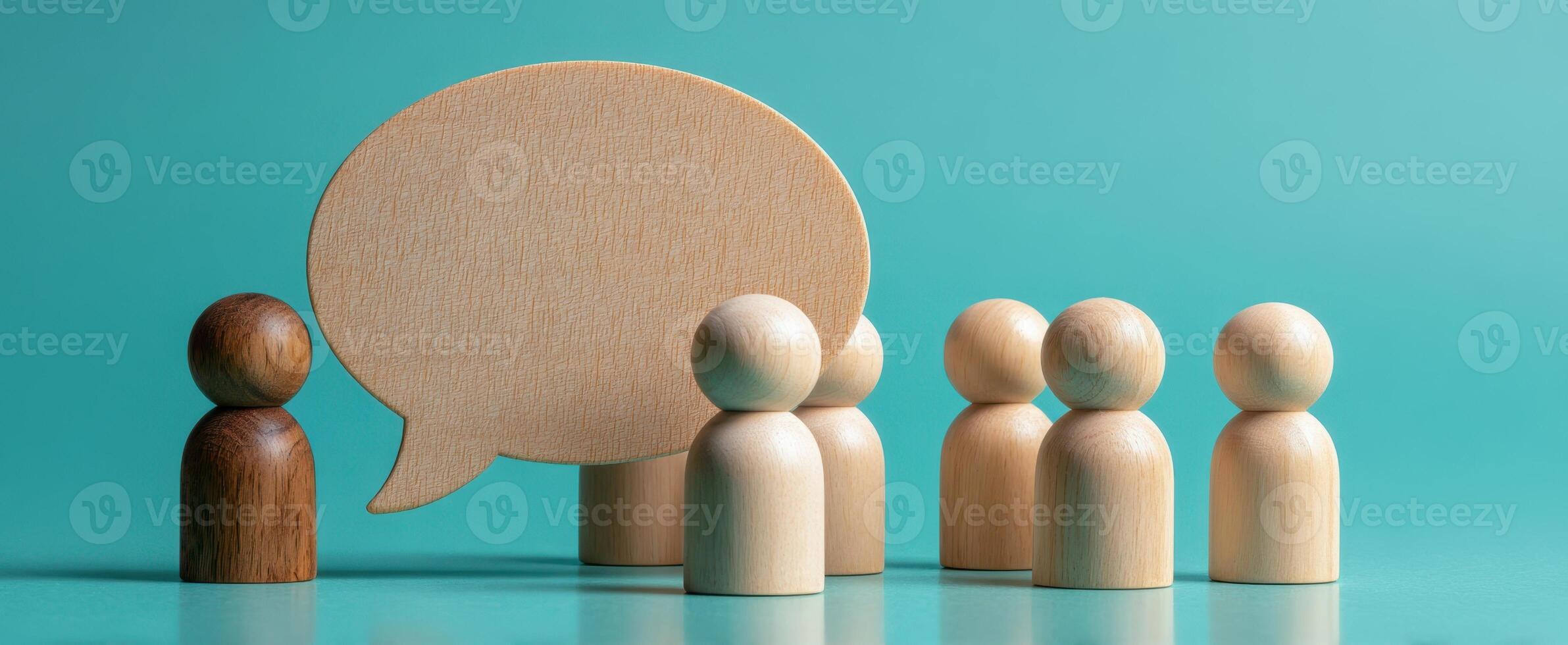 The wooden figures engaging in a dialogue about ideas and teamwork. photo