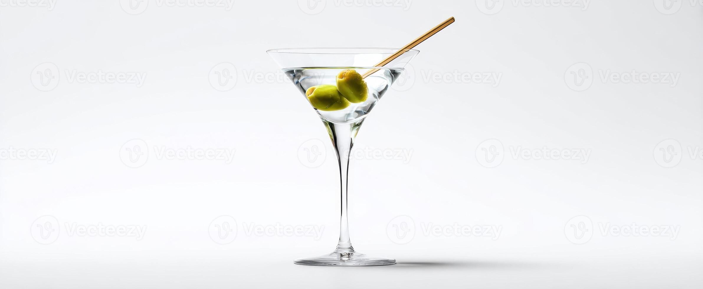 The elegant martini glass with olives and a gold stirrer on a minimalist background. photo