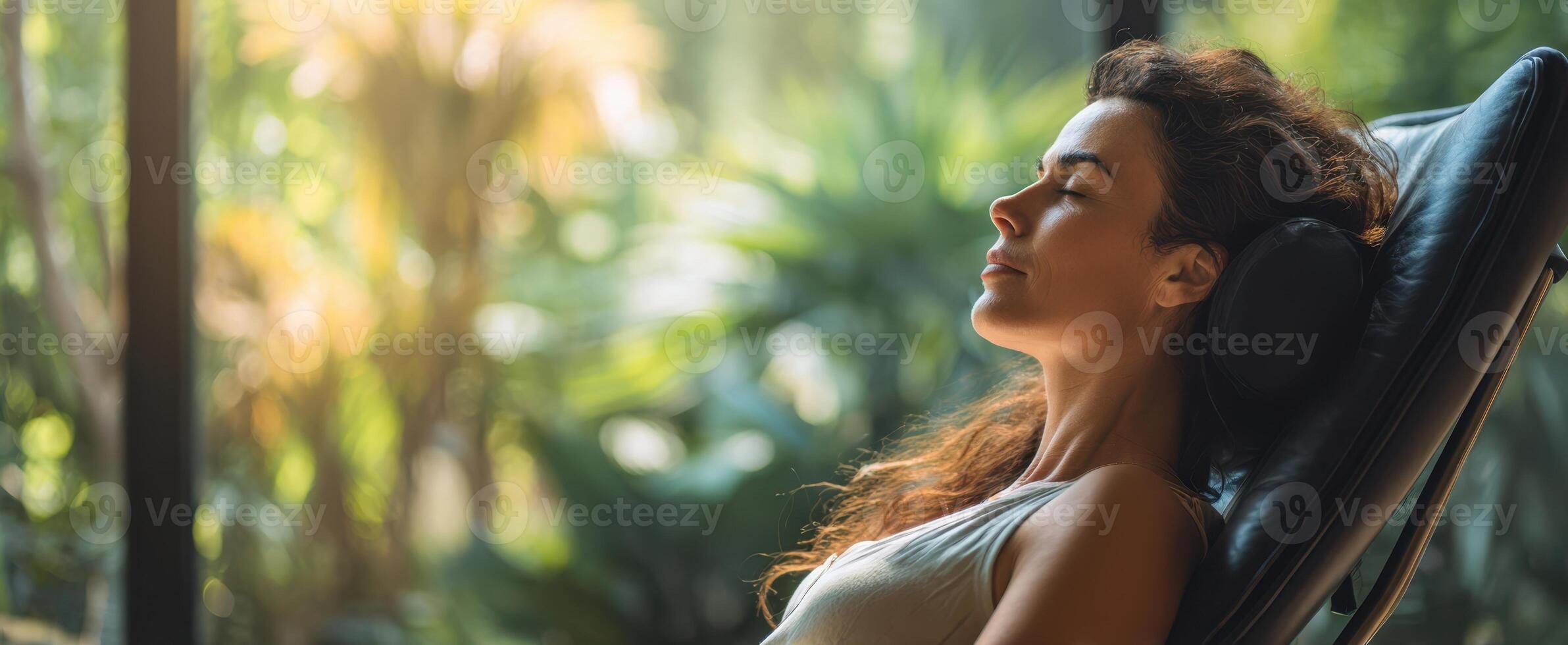 The serene woman enjoying tranquility in a lush indoor environment. photo