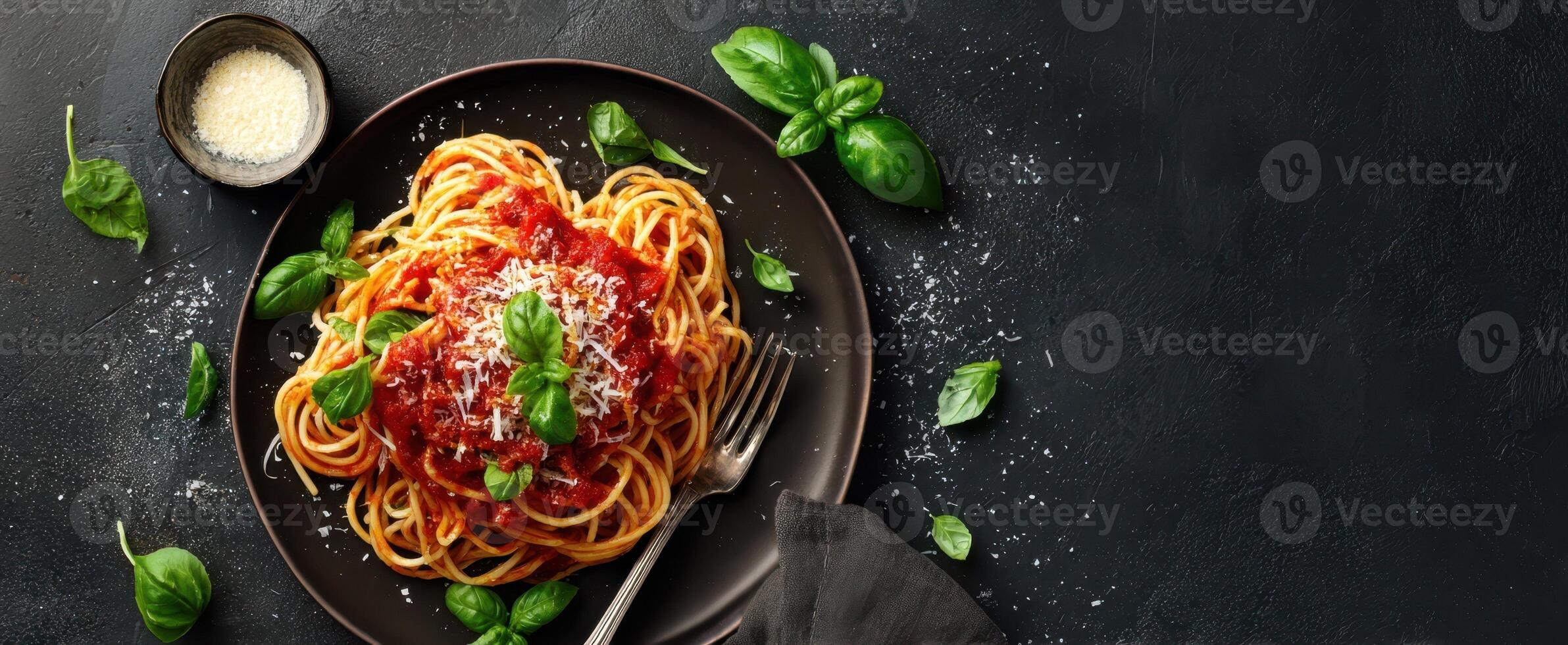 The vibrant plate of spaghetti served with fresh basil and tomato sauce photo