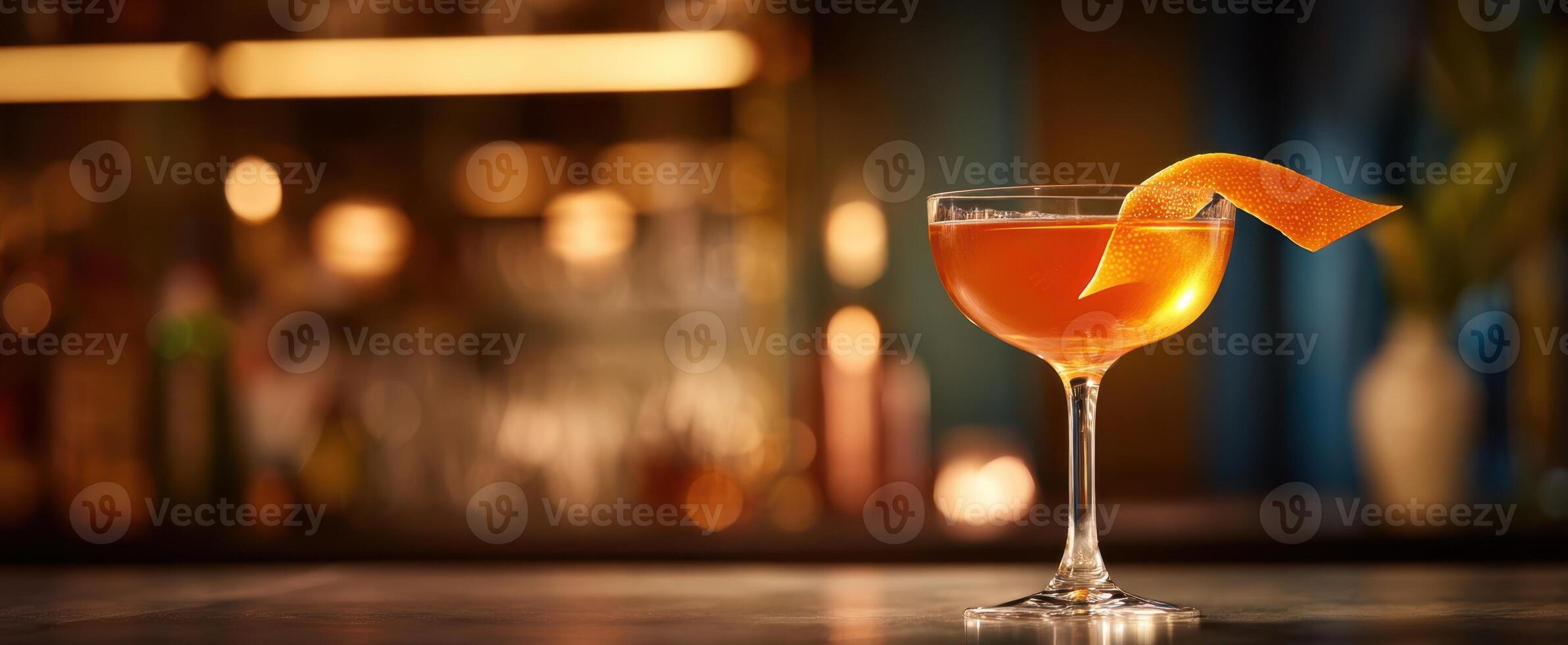 The elegant cocktail garnished with orange peel in a stylish bar setting. photo