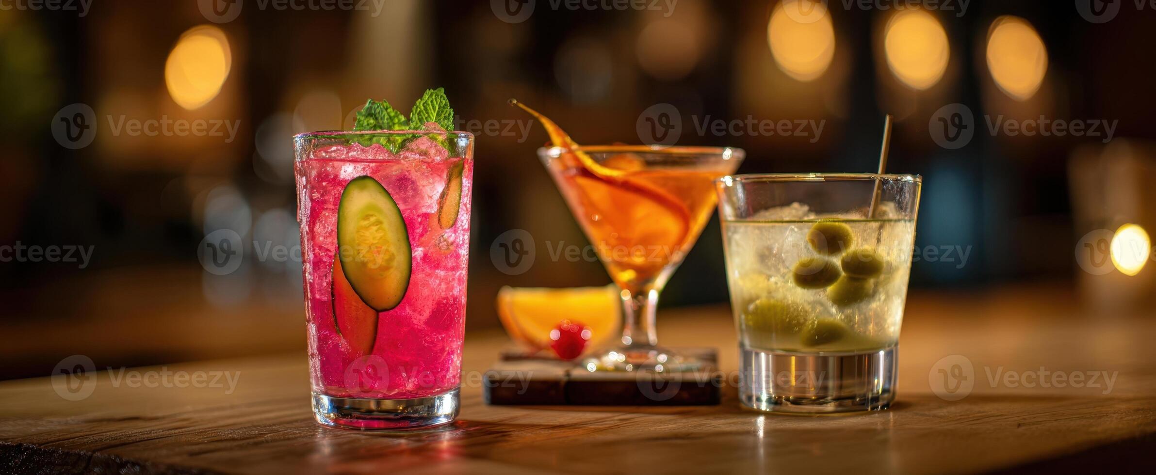 The assortment of vibrant cocktails on a rustic wooden table. photo