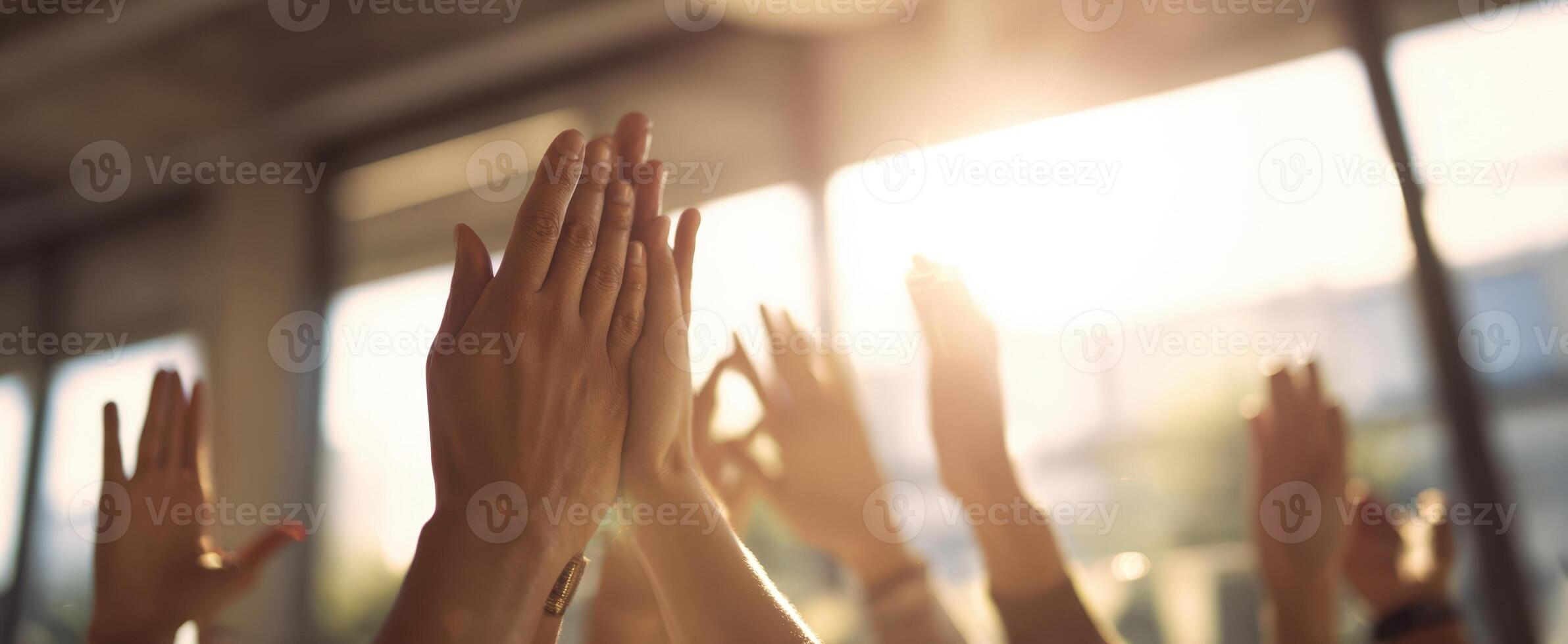 The hands applauding in a warm, vibrant atmosphere of celebration and community engagement. photo