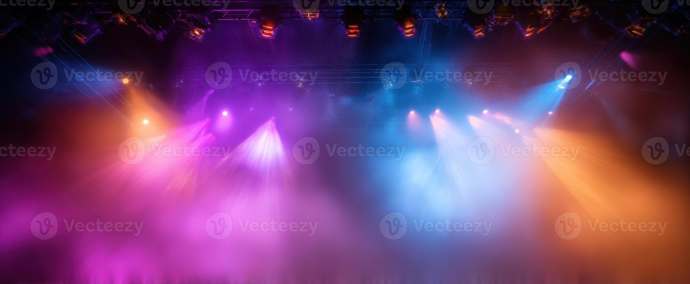 The vibrant stage illuminated by colorful lights and fog during a live performance photo