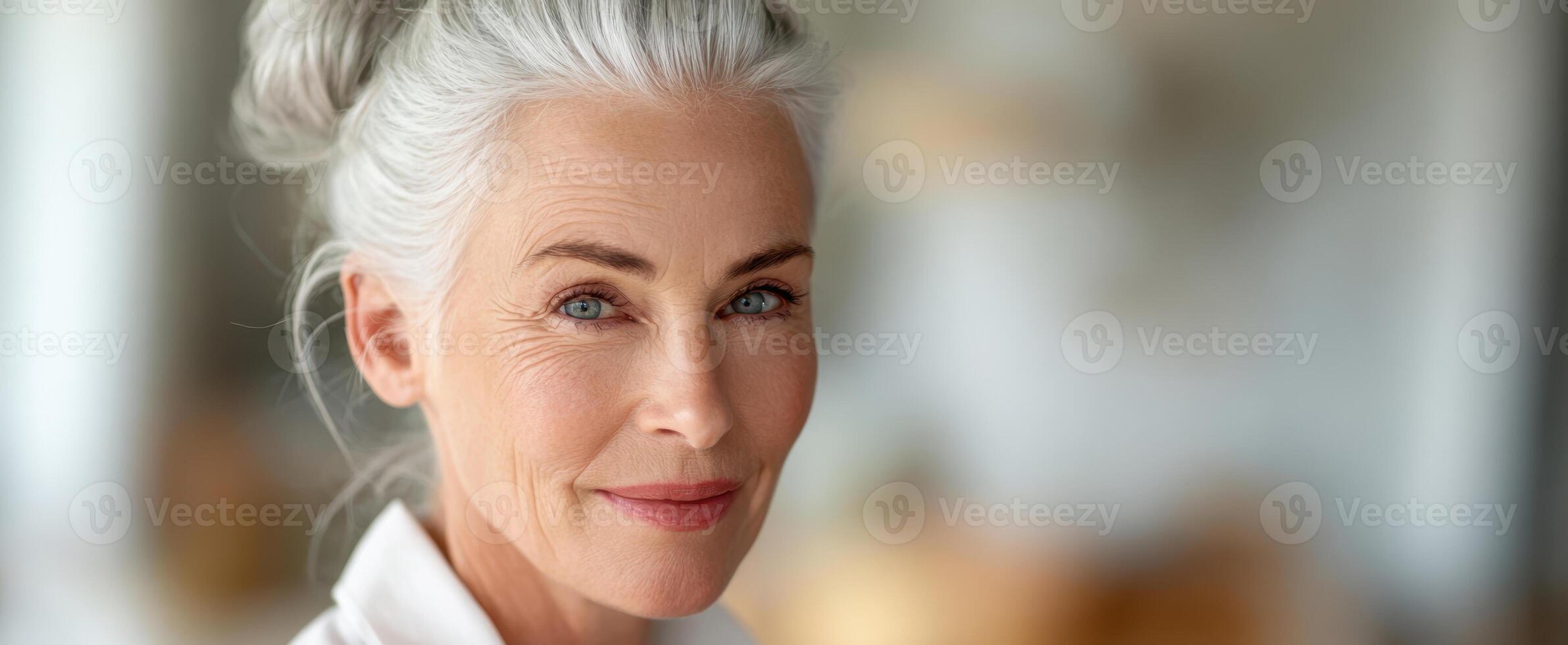 The radiant older woman displaying confidence and elegance in a bright setting photo