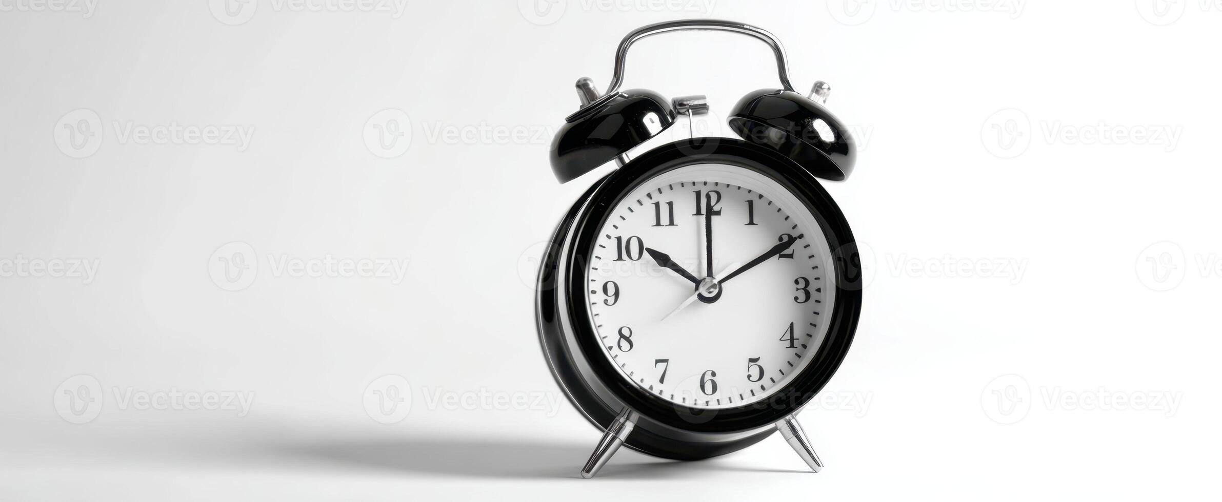 The vintage alarm clock showing precise time on a minimalistic background. photo