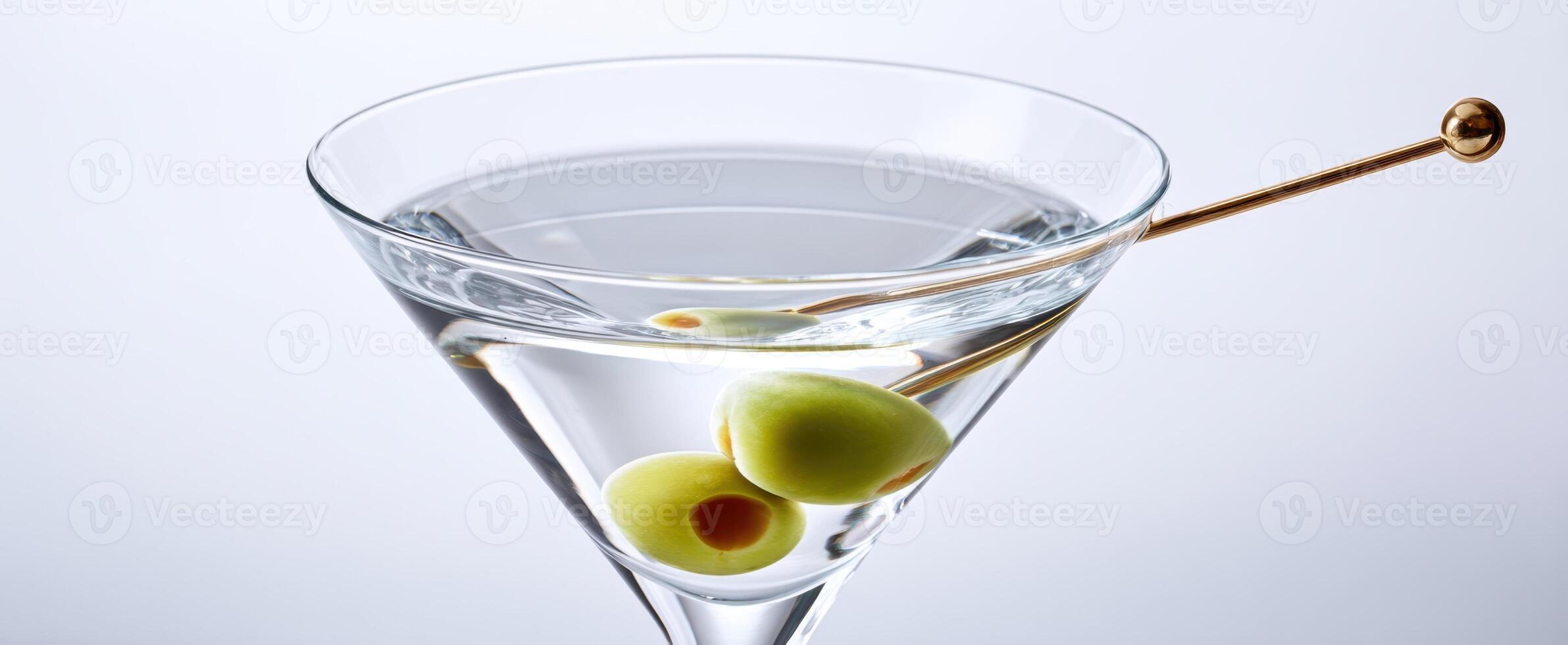 The elegant martini garnished with olives in a stylish glass. photo