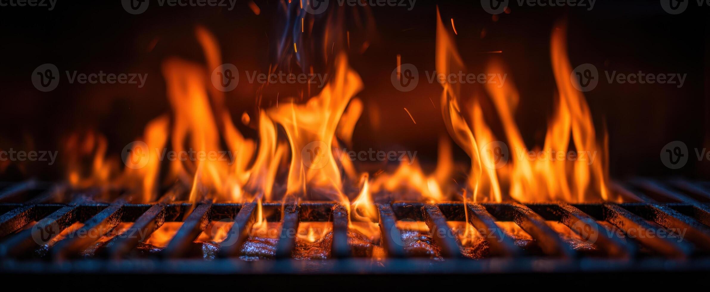 The flickering flames of a grill providing warmth and culinary excitement. photo