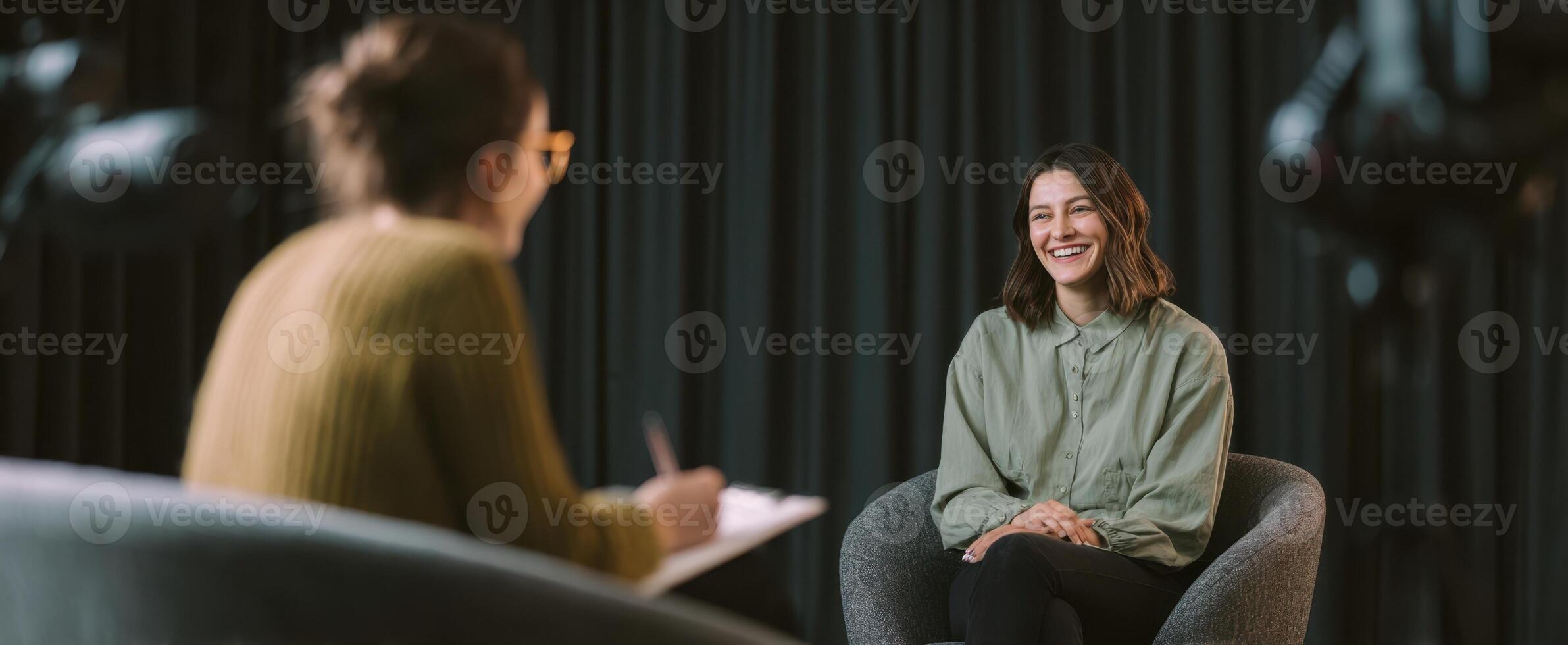 The smiling woman engaged in a thoughtful interview setting. photo