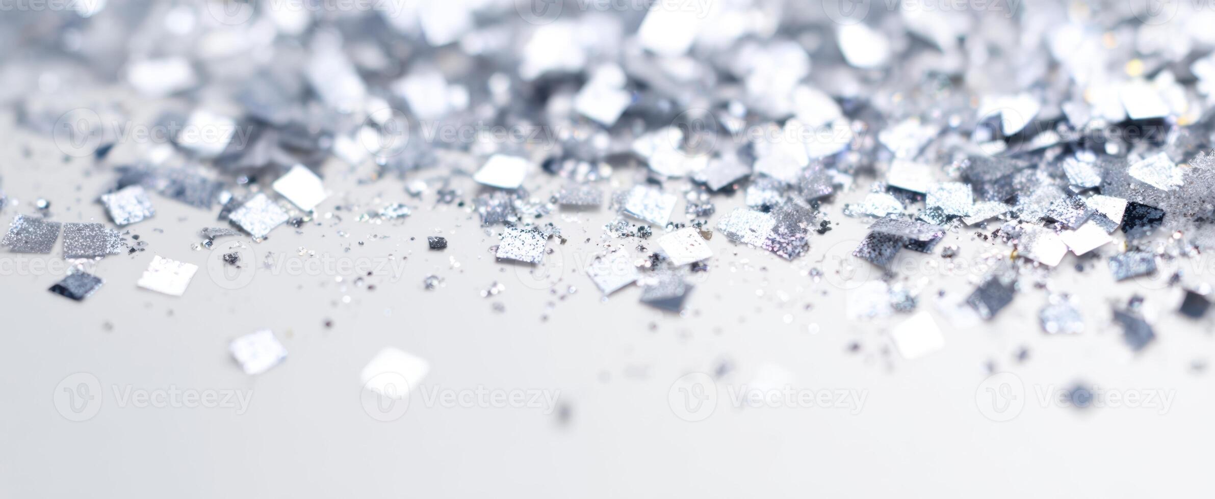 The shimmering silver glitter scattered on a surface for artistic decor. photo
