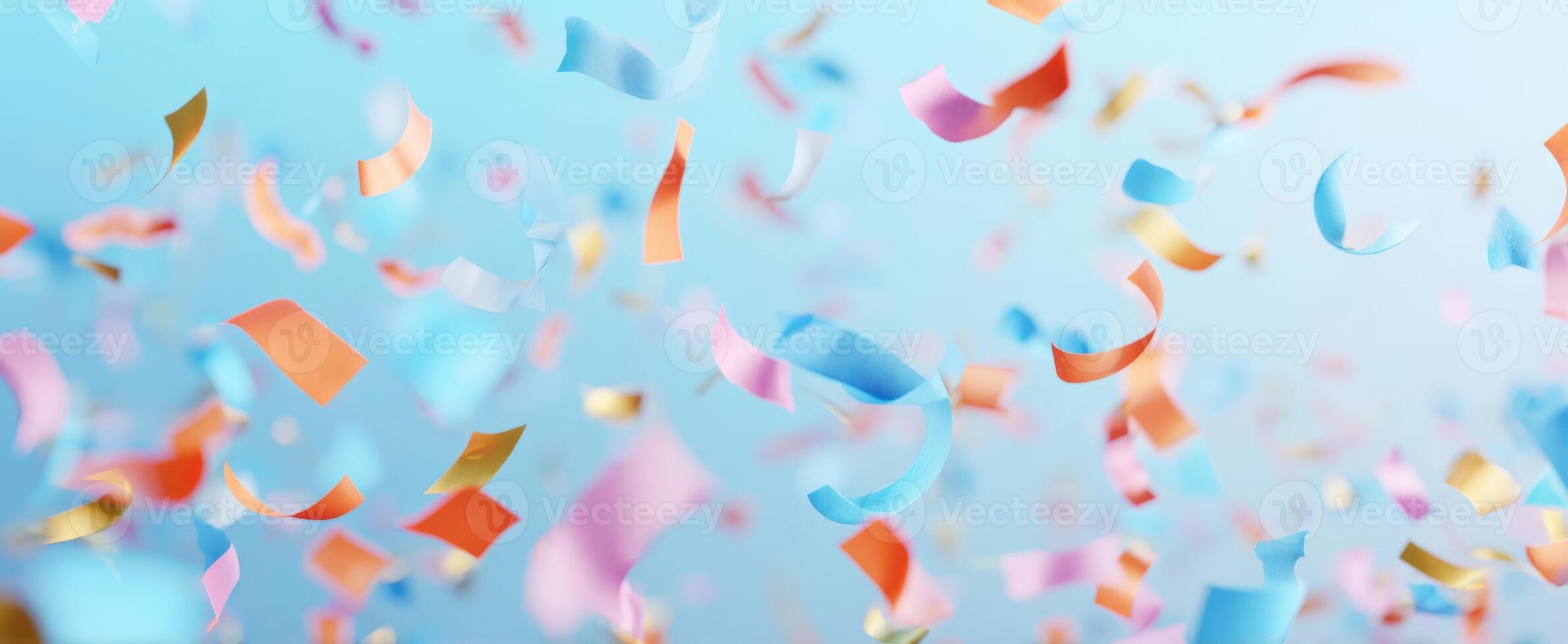 The Colorful Confetti Shower Against a Soft Blue Background photo