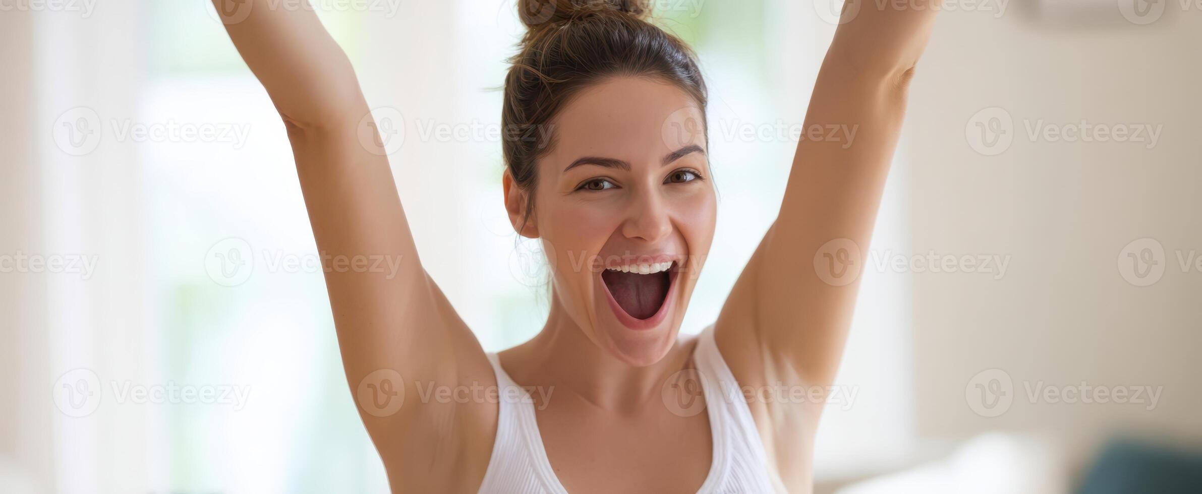 The woman expressing joy and excitement in a bright indoor setting. photo