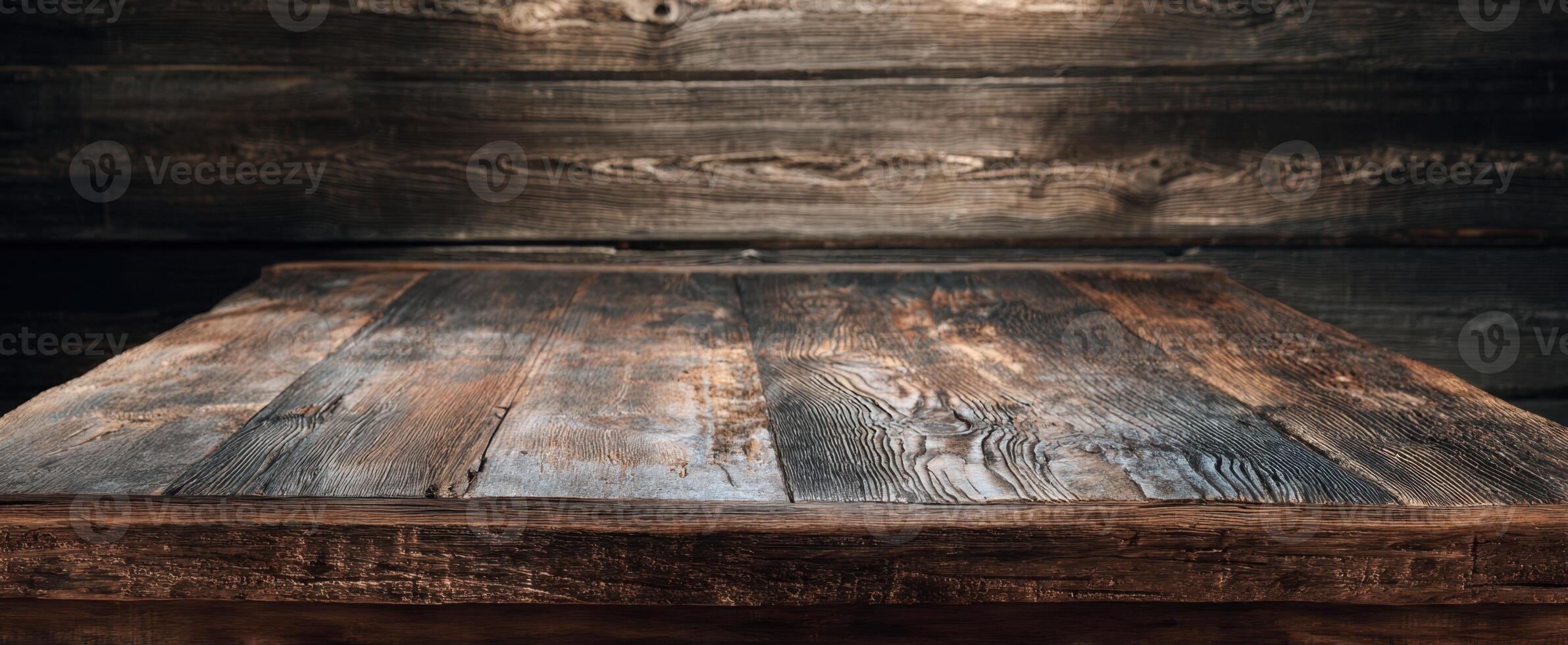 The rustic wooden table with rich textures set against a dark background. photo