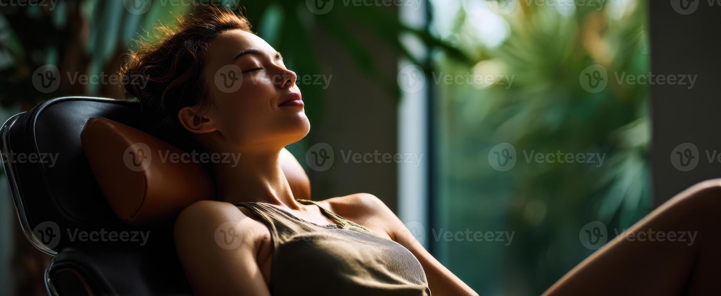 The serene woman enjoying relaxation in a peaceful indoor environment. photo