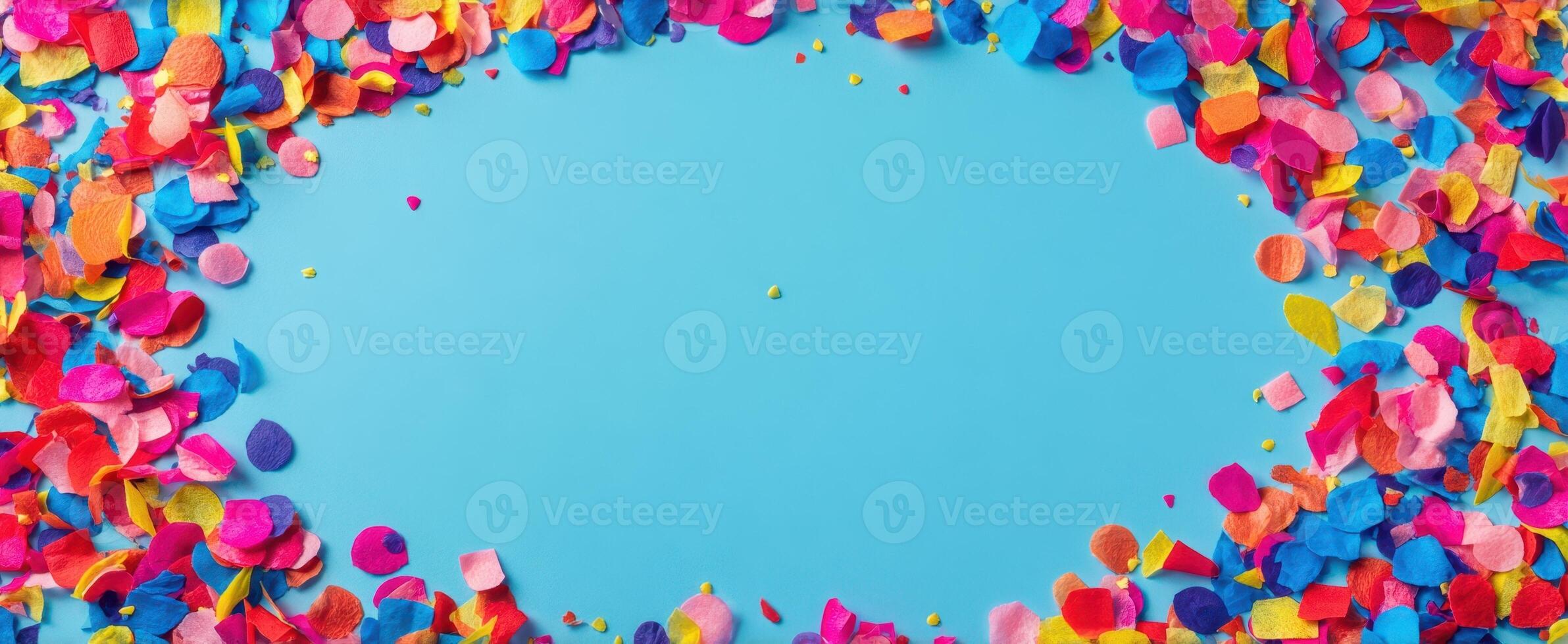 The colorful confetti creating a vibrant festive atmosphere on blue background. photo