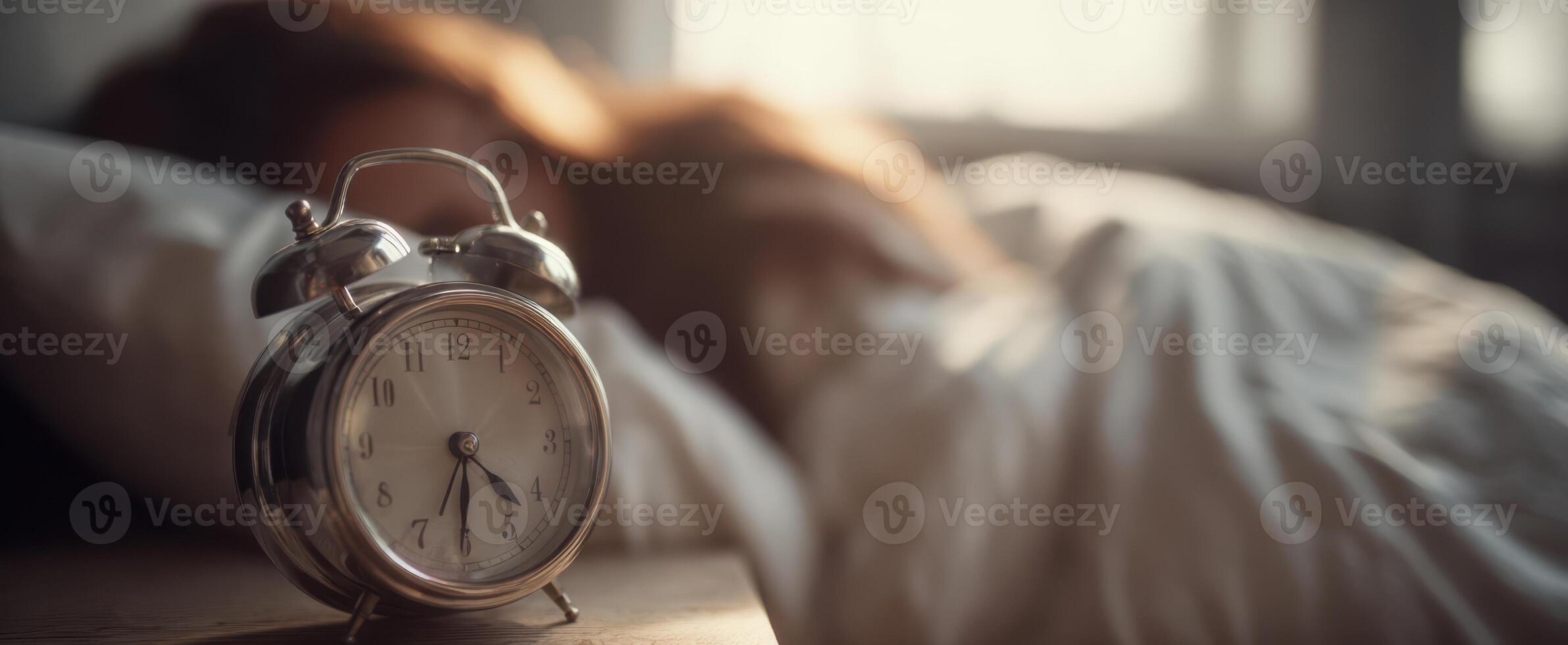 The vintage alarm clock beside a peaceful sleeper in a cozy bedroom. photo
