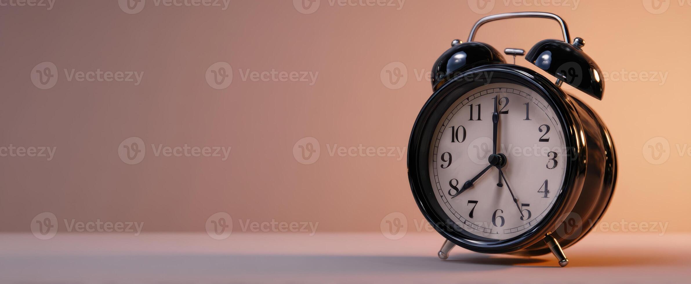 The elegant black alarm clock on a neutral background displaying the time. photo