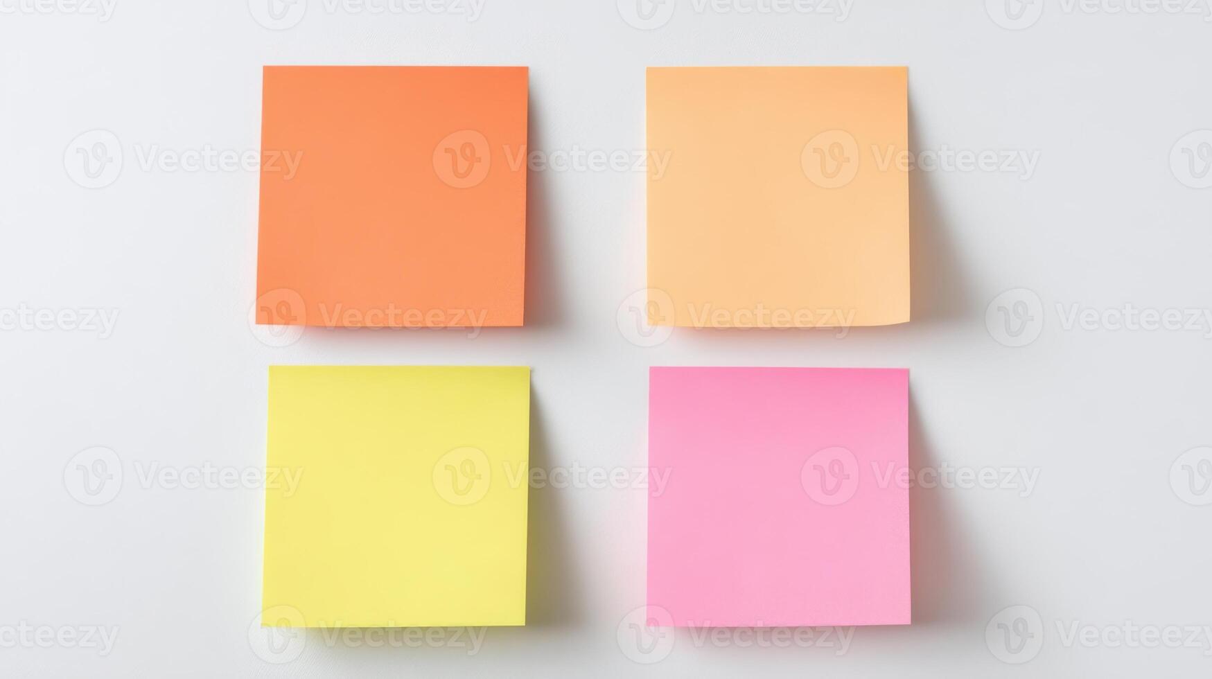 The colorful sticky notes arranged in a neat square layout on a table. photo