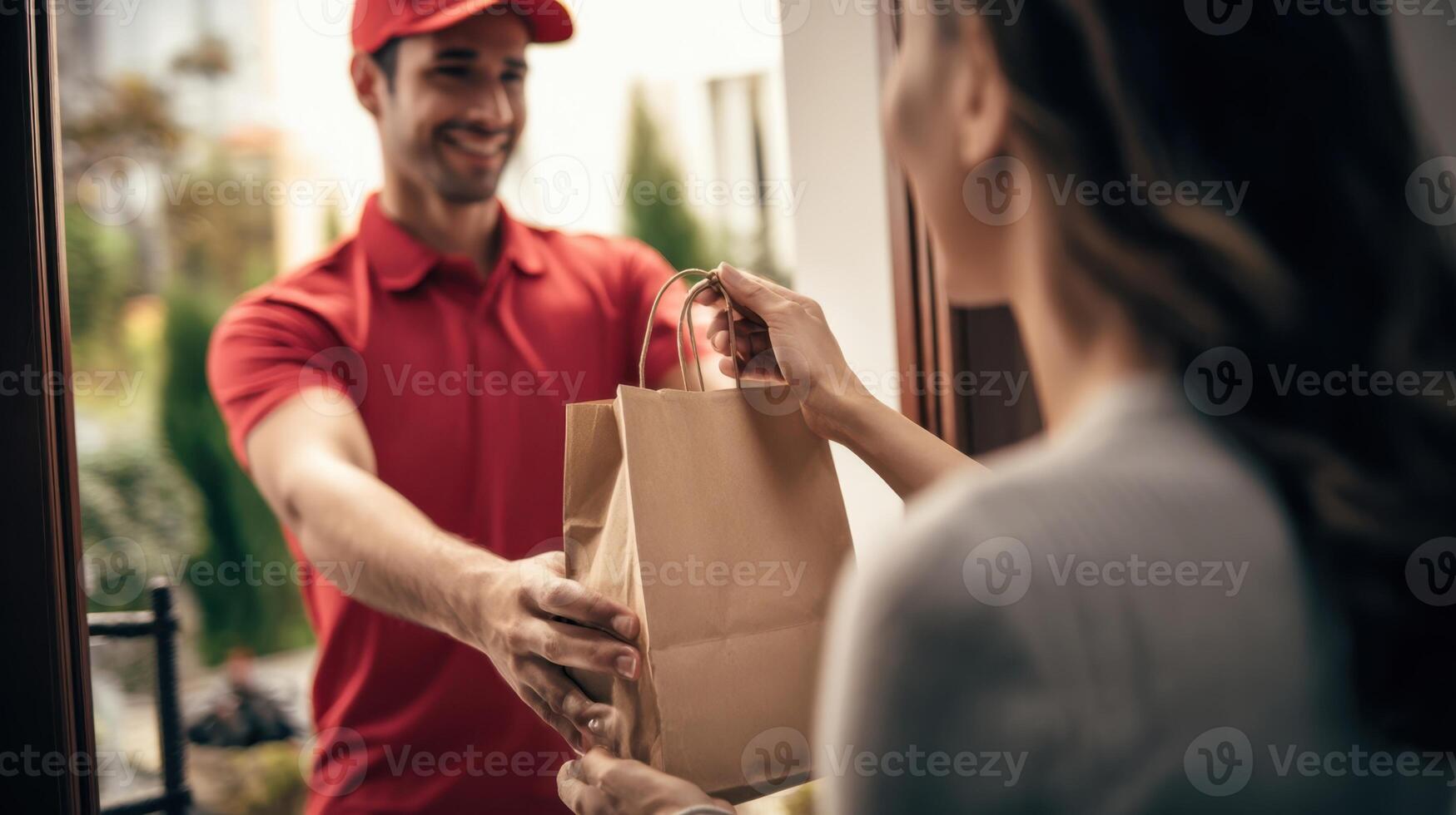 The delivery person hands over food to a satisfied customer at the doorstep. photo
