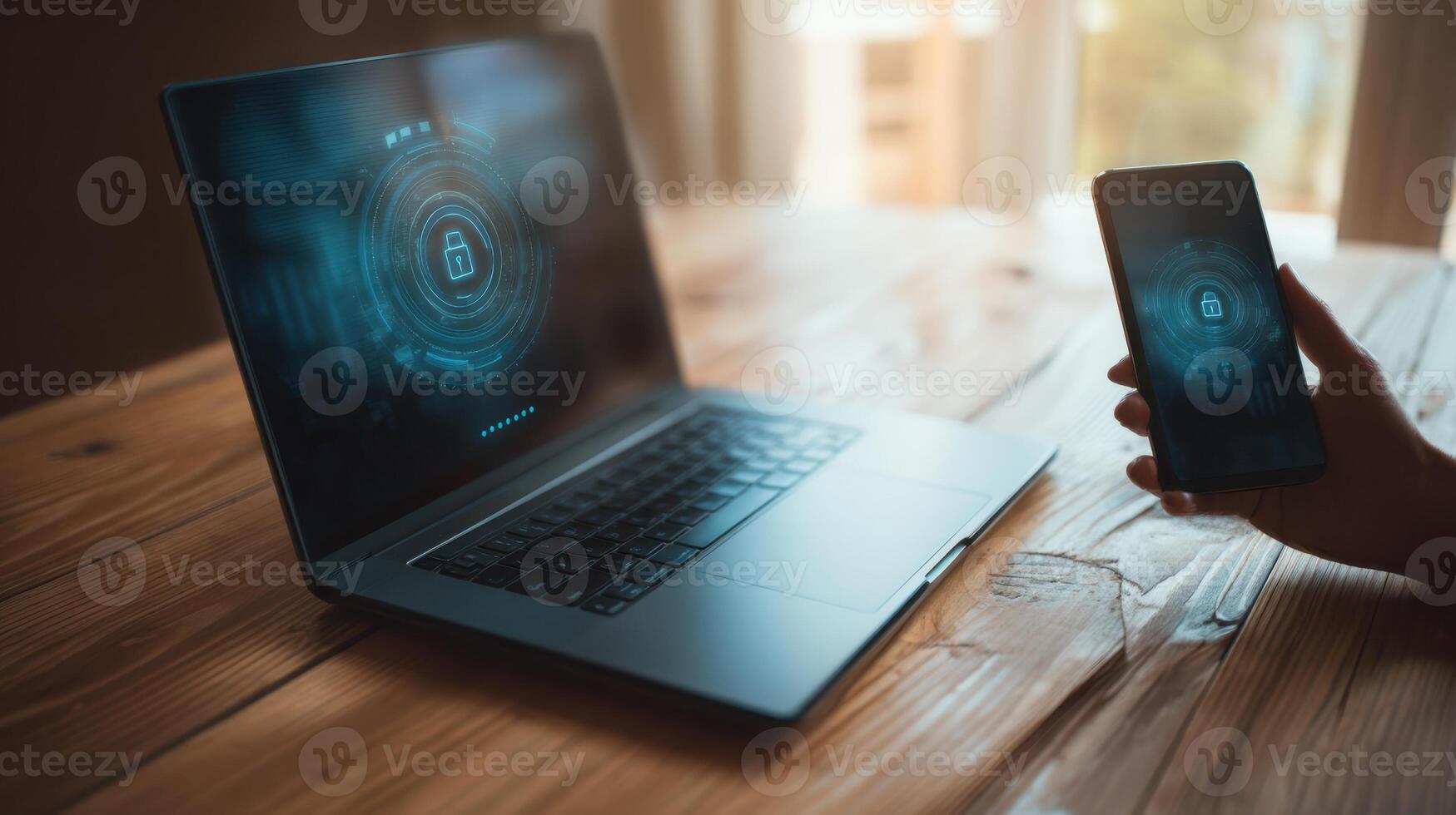 The laptop and smartphone showcasing advanced digital security features on a wooden table. photo