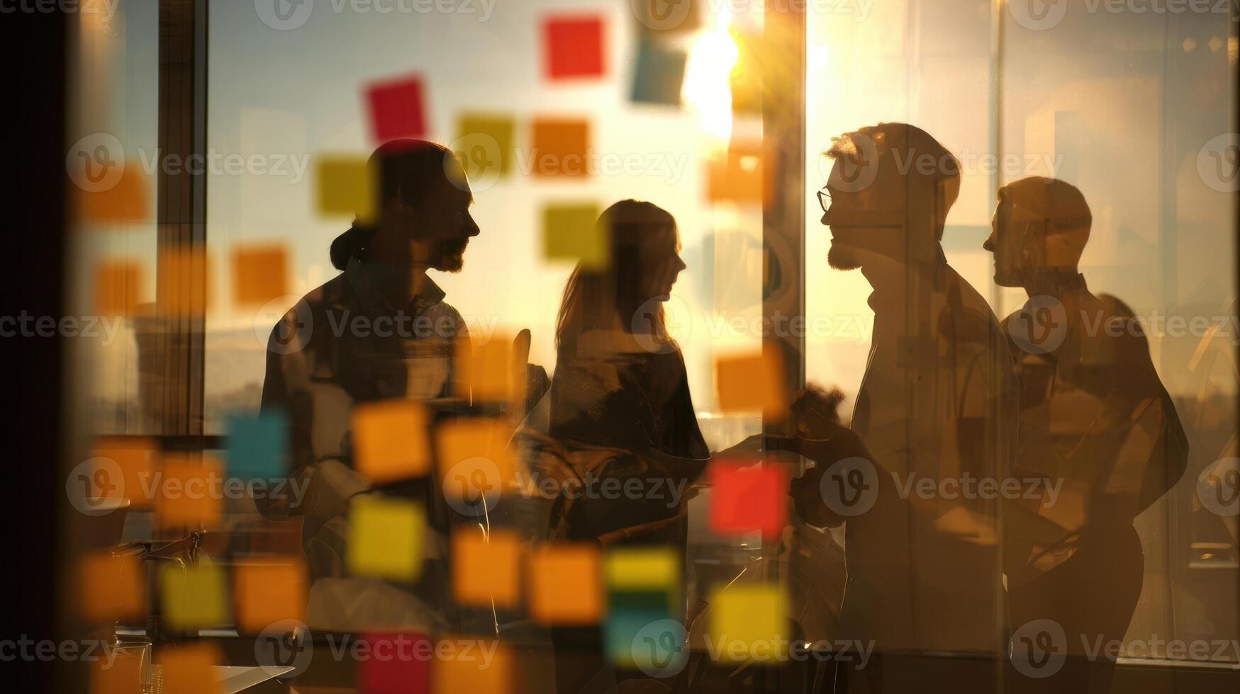 The vibrant silhouettes of professionals collaborating in an inspiring office setting. photo