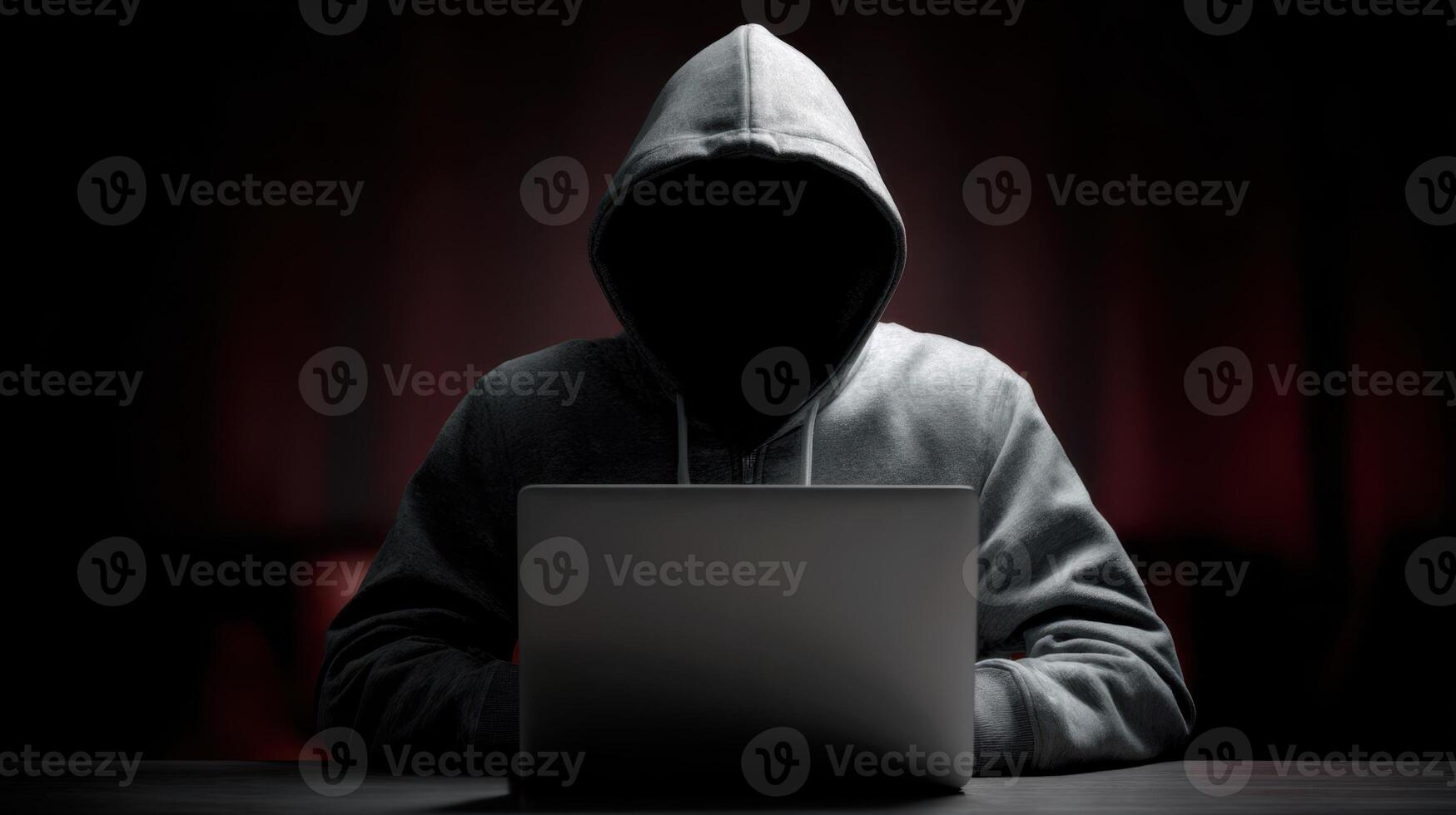 The mysterious figure working on a laptop in a dark, atmospheric setting. photo