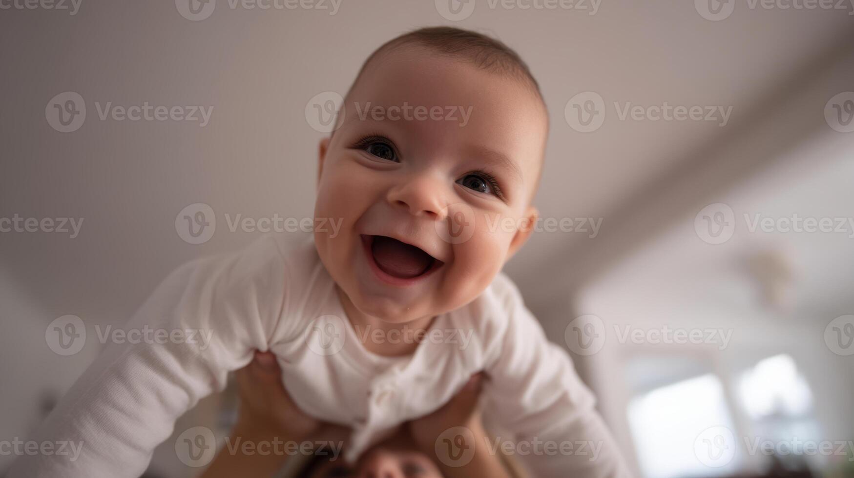 The joyful baby being playfully lifted by a caring parent in a cozy setting. photo