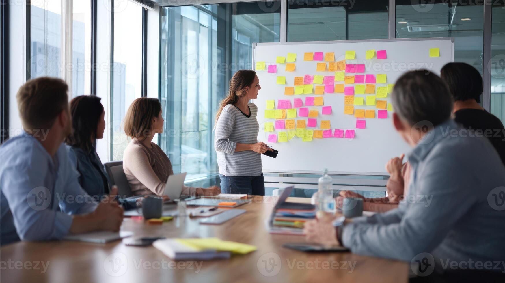 The team collaborates actively during a brainstorming session in a modern office. photo