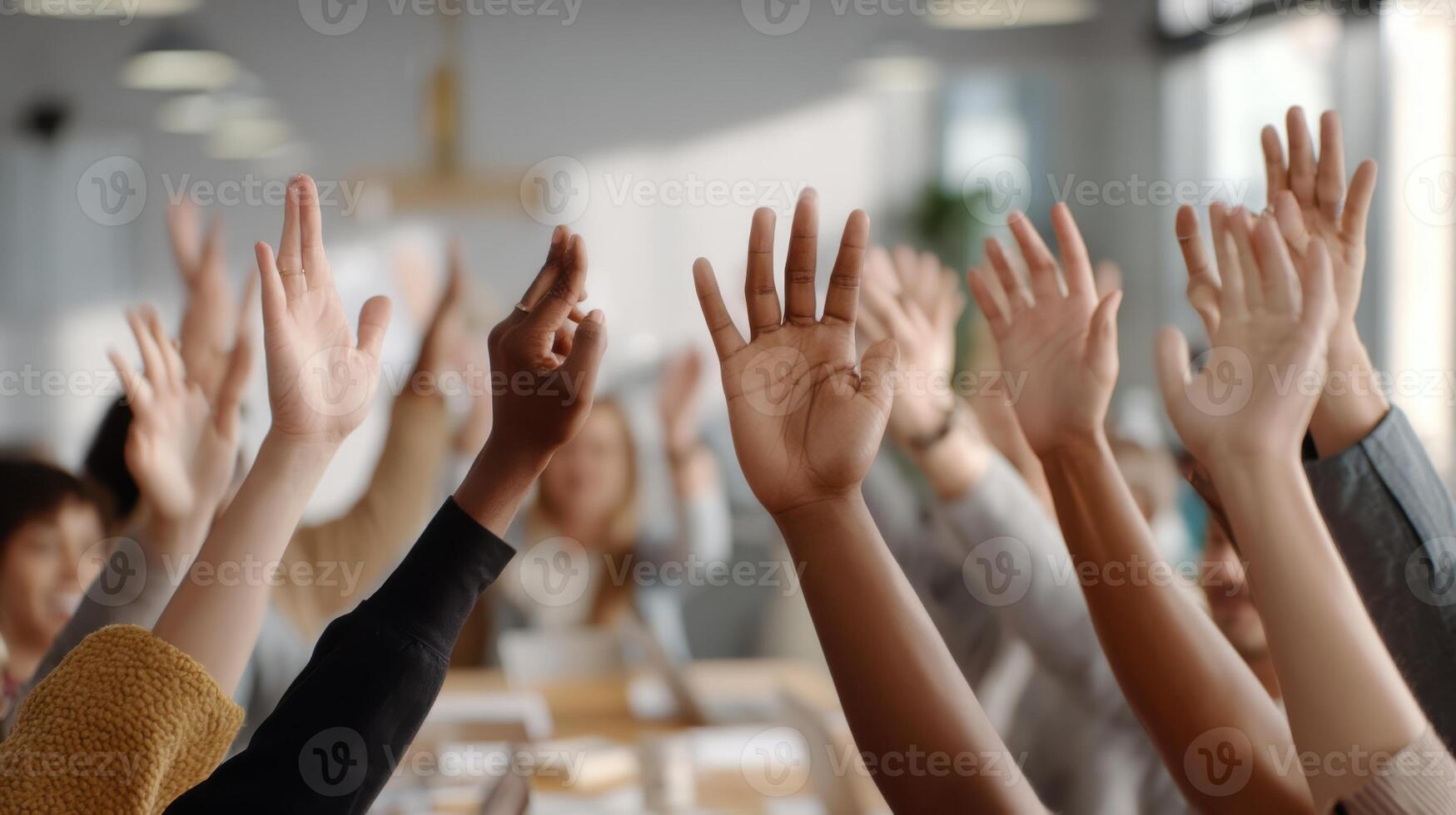 The hands of engaged participants raised during an interactive meeting session. photo