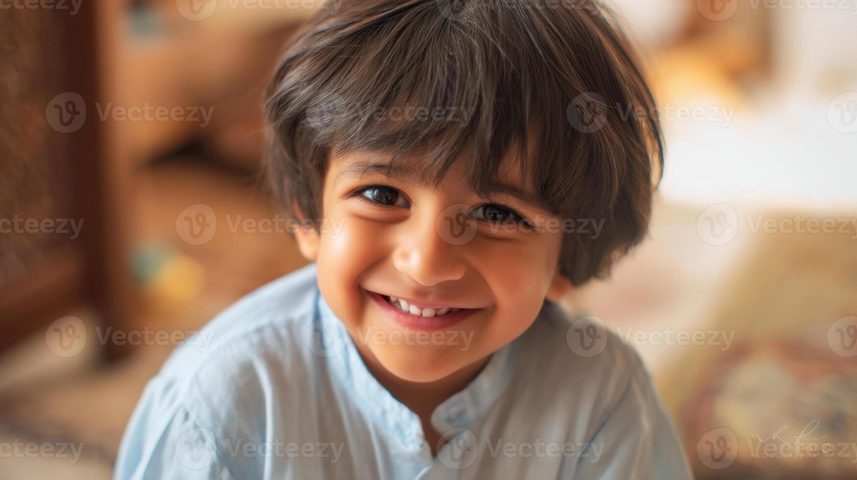 The smiling boy capturing joy and innocence in a warm, inviting indoor setting. photo