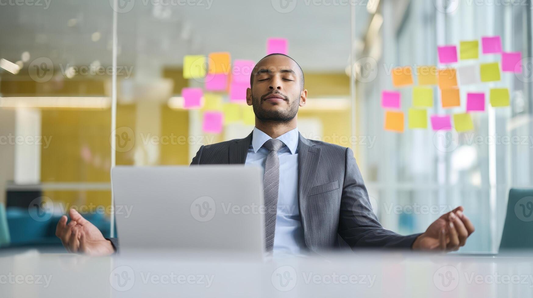 The professional man meditating at his desk for improved focus and productivity. photo